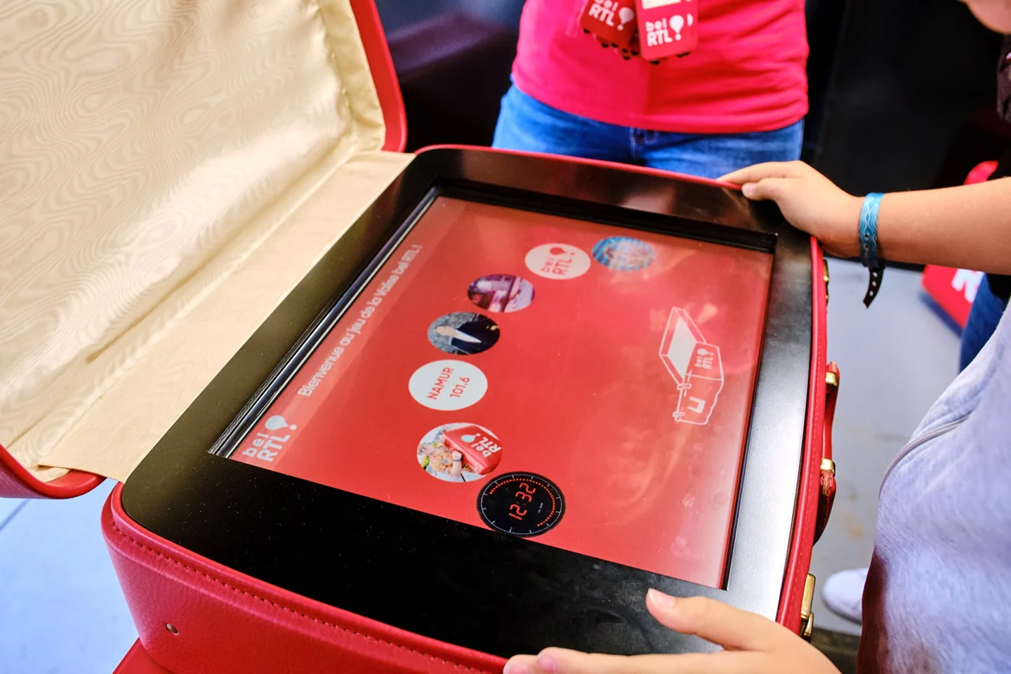 Close-up of the touchscreen game interface inside the branded suitcase